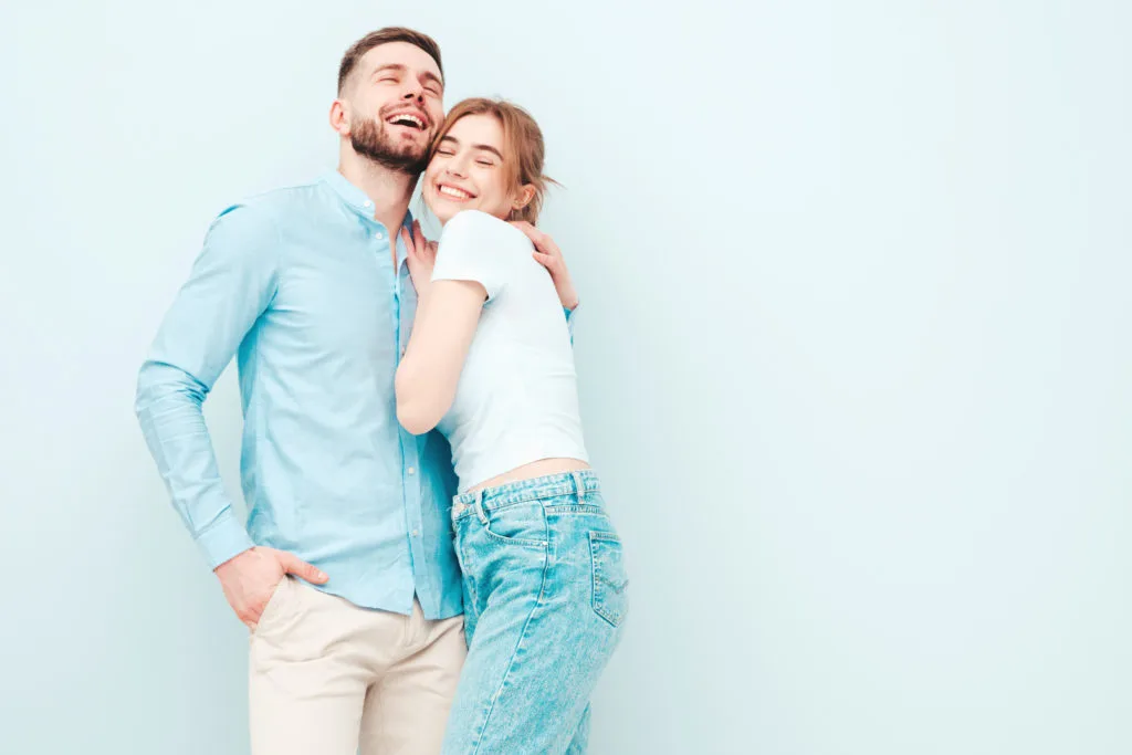 Pareja feliz sonriendo abrazados.